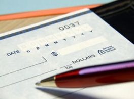 Pen writing a Check. Prevent Financial Fraud. Runey & Associates Wealth Management. Mount Pleasant, SC.